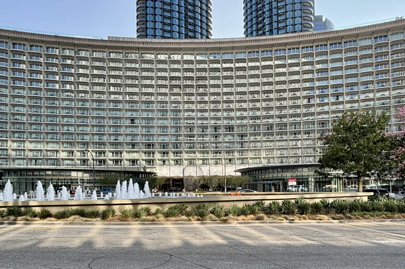 The curved facade of the Fairmont Century Plaza with fountains in front, Century City