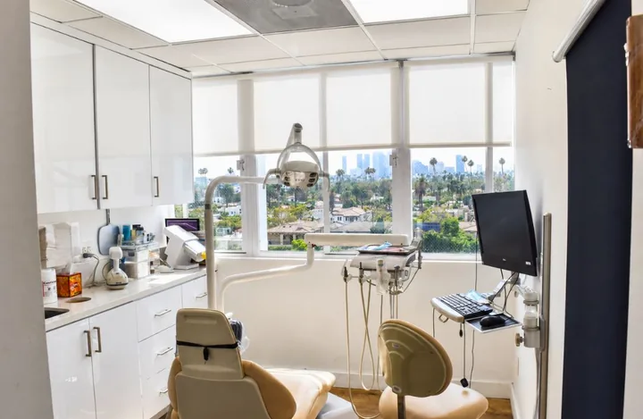 Bright treatment room with a window over Beverly Hills