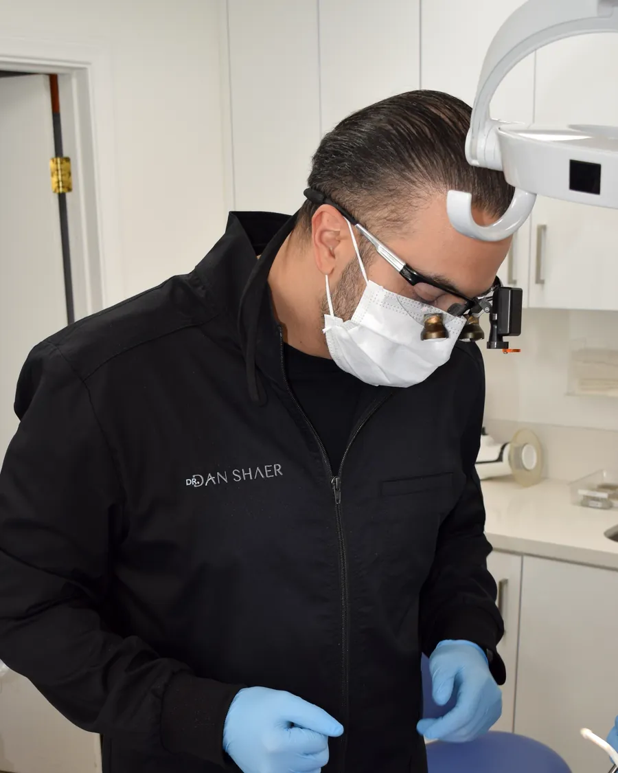 Dr. Dan Shaer in surgical loupes preparing for a full arch implant procedure