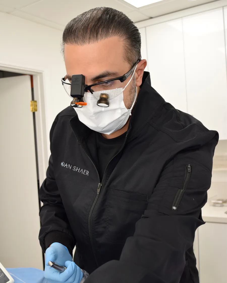 Dr. Dan Shaer reaching for an instrument during an appointment at the studio