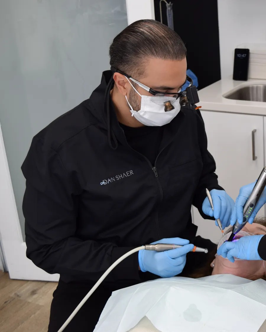 Dr. Dan Shaer and his assistant working together on a patient's restoration